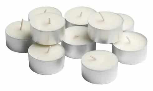 Ten tealight candles layered on each other on a white background.